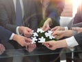 Business team solving puzzle together. Royalty Free Stock Photo