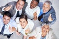Business team spirit. Portrait of a group of enthusiastic businesspeople showing thumbs up. Royalty Free Stock Photo