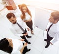 Business team standing in front of a flipchart. Royalty Free Stock Photo