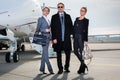 Business team standing in front of private jet Royalty Free Stock Photo