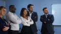 Business team standing with serious look in office
