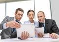 Business team with tablet pc having discussion Royalty Free Stock Photo