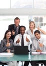 Business team with thumbs up smiling at the camera Royalty Free Stock Photo