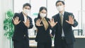 A business team wearing a working mask