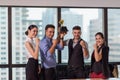 Business team winning trophy in the office, Business People with teamwork in award and successful showing trophy and rewarded Royalty Free Stock Photo