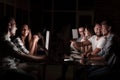 Business team working with computer overtime at night and low light Royalty Free Stock Photo