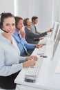 Business team working on computers and wearing headsets Royalty Free Stock Photo