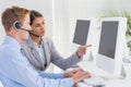 Business team working on computers and wearing headsets Royalty Free Stock Photo