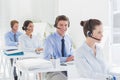 Business team working on computers and wearing headsets Royalty Free Stock Photo