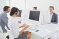 Business team working on computers and wearing headsets Royalty Free Stock Photo