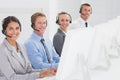 Business team working on computers and wearing headsets Royalty Free Stock Photo