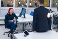 Business team working on new project and smiling. Man and woman sitting together in modern office for project discussion Royalty Free Stock Photo