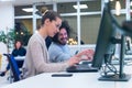 Business team working on new project and smiling. Man and woman sitting together in modern office for project discussion Royalty Free Stock Photo