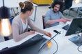 Business team working on new project and smiling. Man and woman sitting together in modern office for project discussion Royalty Free Stock Photo