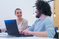 Business team working on new project and smiling. Man and woman sitting together in modern office for project discussion Royalty Free Stock Photo