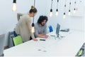 Business team working on new project and smiling. Man and woman sitting together in modern office for project discussion Royalty Free Stock Photo