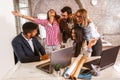 Business people working on new project and smiling. Man and women sitting together in modern office Royalty Free Stock Photo