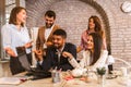 Business people working on new project and smiling. Man and women sitting together in modern office Royalty Free Stock Photo