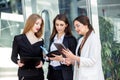Business team working on a project. Three young people with devices. Concept for business, marketing, finance, work, colleagues Royalty Free Stock Photo