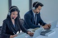 Business team working together at a call center wearing headsets Royalty Free Stock Photo