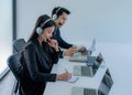 Business team working together at a call center wearing headsets Royalty Free Stock Photo