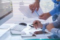 Business team working together on financial analytics report.