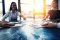 Business teamwork at the office. Workers join puzzle pieces on the desk. Partnership concept Royalty Free Stock Photo