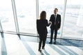 Business, teamwork, partnership, cooperation and people concept - business people shaking hands over panoramic office Royalty Free Stock Photo