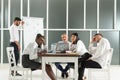 Business, teamwork, people and crisis concept - business team sitting sad and solving problem in office Royalty Free Stock Photo