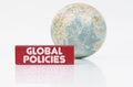 Near the globe is a red plaque with the inscription - Global Policies