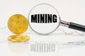 There are bitcoins on the chart and there is a magnifying glass with the inscription - Mining