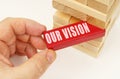 From the tower with wooden planks, they take out a red plaque with the inscription - Our vision Royalty Free Stock Photo