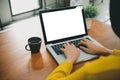 Digital lifestyle working outside office. Woman hands typing laptop computer with blank screen on table in coffee shop. Royalty Free Stock Photo