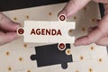 Business, Technology, Internet and network concept. Young businessman shows the word: Agenda