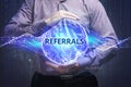 Business, Technology, Internet and network concept. Young businessman shows the word: Referrals