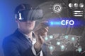 Business, Technology, Internet and network concept. Young businessman working in virtual reality glasses sees the inscription: CFO