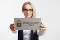 Business, Technology, Internet and network concept. Young girl holding a sign with an inscription CYBERSECURITY PLAN Royalty Free Stock Photo