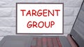 TARGET GROUP a phrase written on a magnetic board next to a laptop with a glowing keyboard