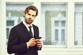 Business, technology and people concept, serious businessman with smartphone Royalty Free Stock Photo