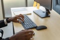 Business, Technology and Work Place Concept. Closeup of Black businessman  hand working desktop computer with keyboard, mouse and Royalty Free Stock Photo