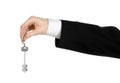 Business theme: real estate agent in the jacket in his hand the key to a new apartment on the white isolated background Royalty Free Stock Photo