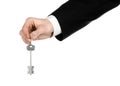 Business theme: real estate agent in the jacket in his hand the key to a new apartment on the white isolated background Royalty Free Stock Photo