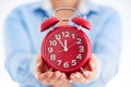 Business time concept. Woman holding alarm clock in his hands cl Royalty Free Stock Photo