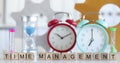 Business time management alarm clock and hourglass