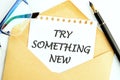 Business, time for something new concept. TRY SOMETHING NEW on a white sheet of notepad sticking out of an envelope Royalty Free Stock Photo