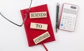 COMPOUND INTEREST text on wooden block on red notebook