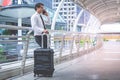 Business tourist traveler with luggage using his mobile phone Royalty Free Stock Photo