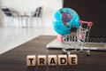 Business Trading and E-Commerce Online and Financial Concept., Computer, Global Model, Shopping Cart and Wooden Cube With Text on Royalty Free Stock Photo