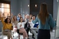 Business trainer answering questions at seminar in hall Royalty Free Stock Photo