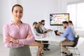 Business trainer in meeting room with interactive board during presentation